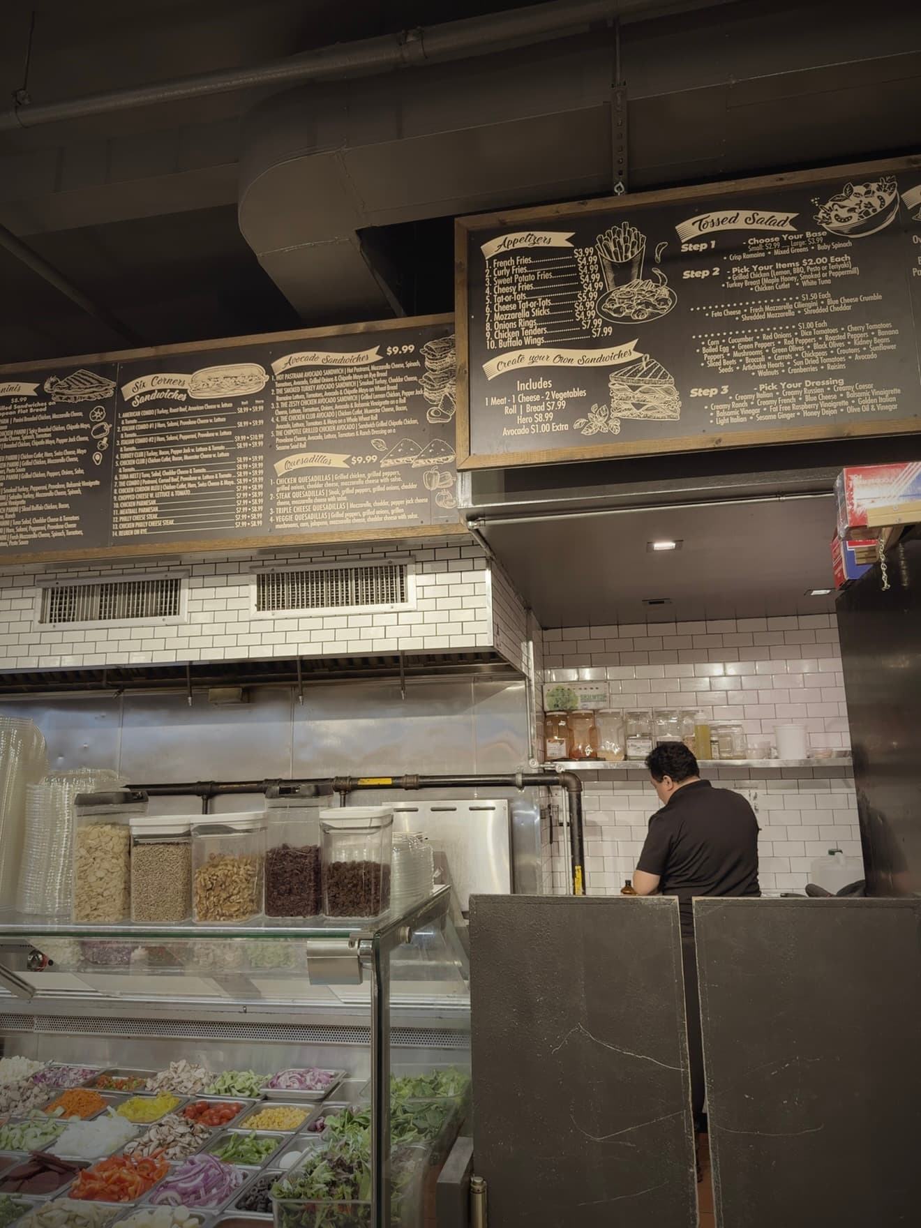 A deli worker behind the counter of a New York deli
